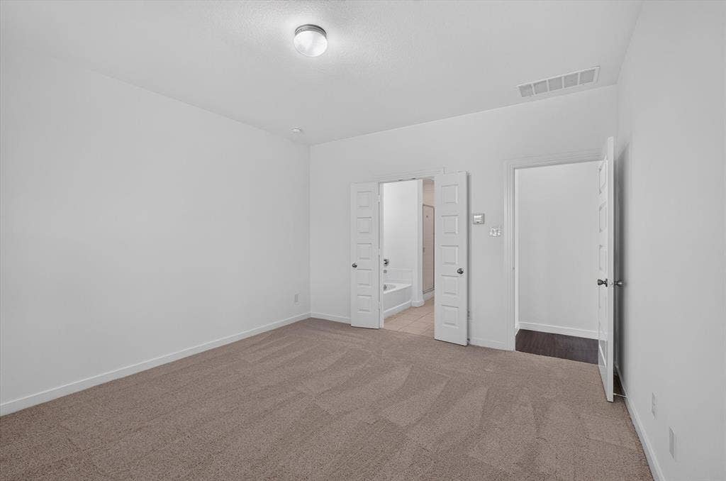 2832 Lolita Way, Forney, TX 75126 Spacious interior room featuring neutral-toned carpet flooring and a simple flush-mount ceiling light fixture