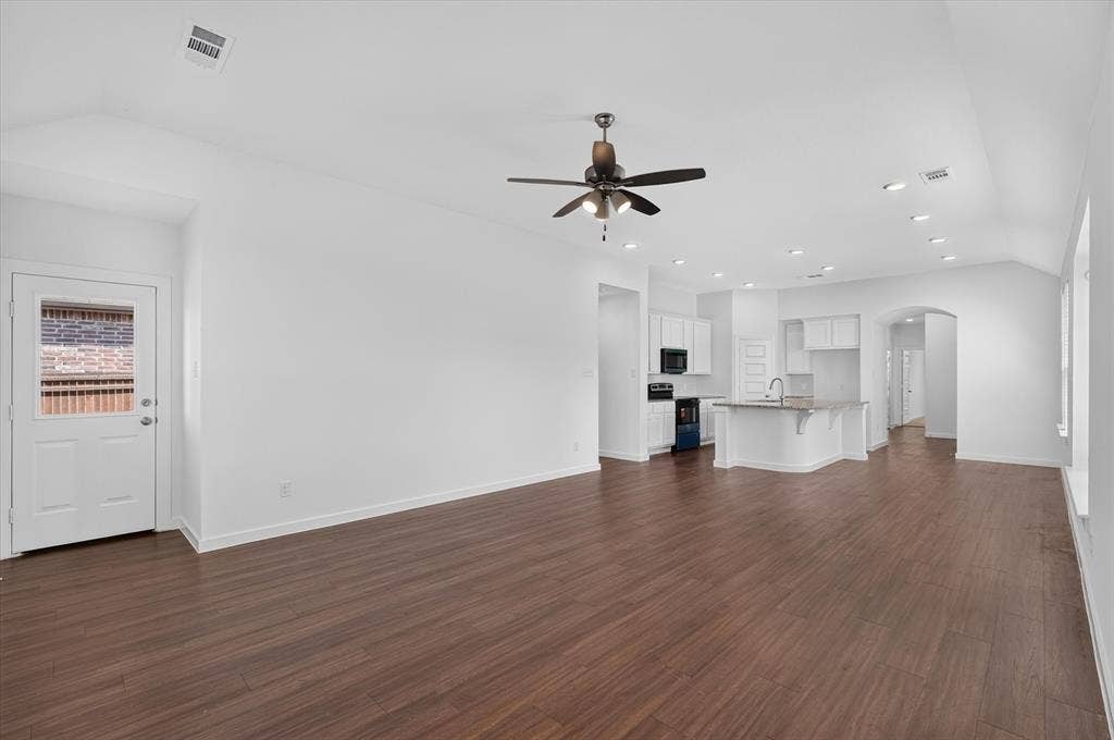 2832 Lolita Way, Forney, TX 75126 Expansive open-concept living area featuring wood-finish flooring, vaulted ceilings, and recessed lighting