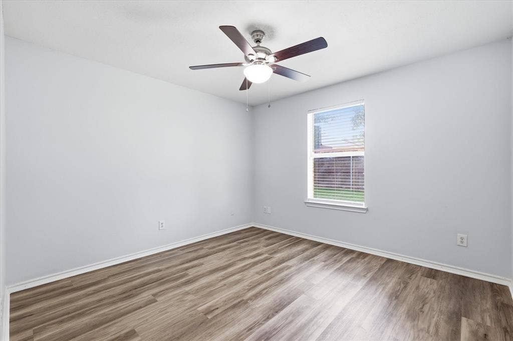 311 Bridlegate Drive, McKinney, TX 75069 Good-sized secondary bedroom with luxury vinyl plank flooring, ideal for a bedroom or home office.