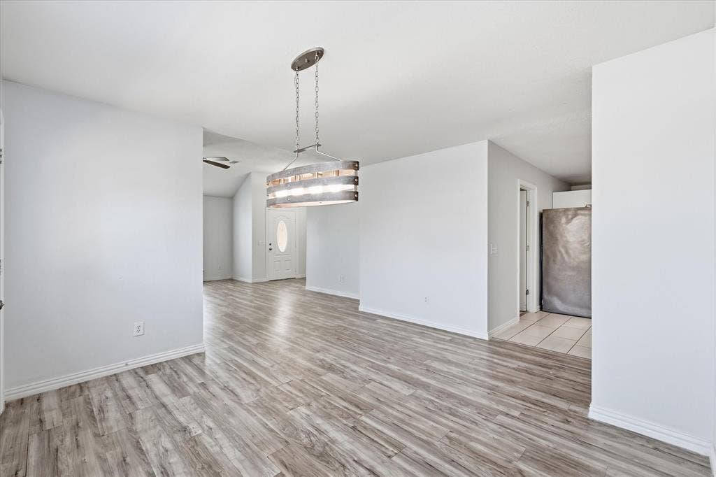 311 Bridlegate Drive, McKinney, TX 75069 Dedicated dining area with luxury vinyl plank flooring, sized for a large gathering table.