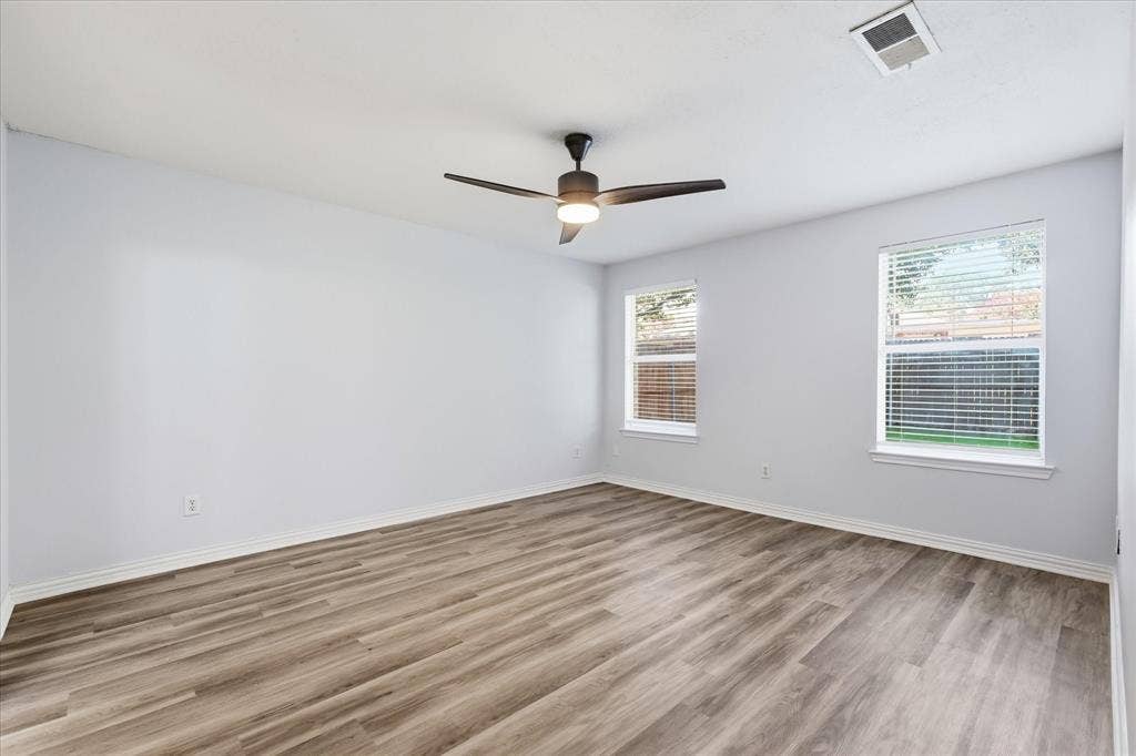 311 Bridlegate Drive, McKinney, TX 75069 Bedroom: Additional spacious secondary bedroom featuring durable luxury vinyl plank flooring throughout.