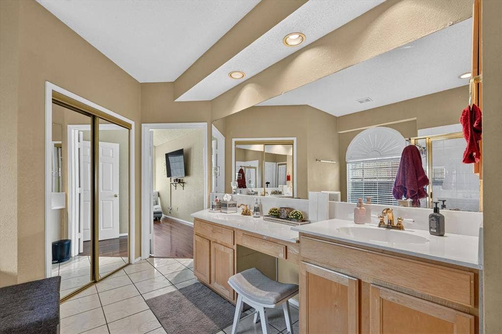 1625 Falmouth Drive, Plano, TX 75025 Bathroom featuring a dual vanity with light wood cabinetry, white countertops, and a full-width mirror