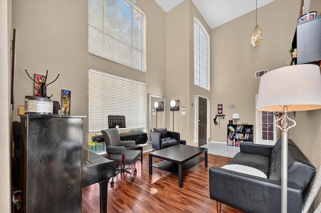 1625 Falmouth Drive, Plano, TX 75025 Living area with vaulted ceilings and wood-finish flooring