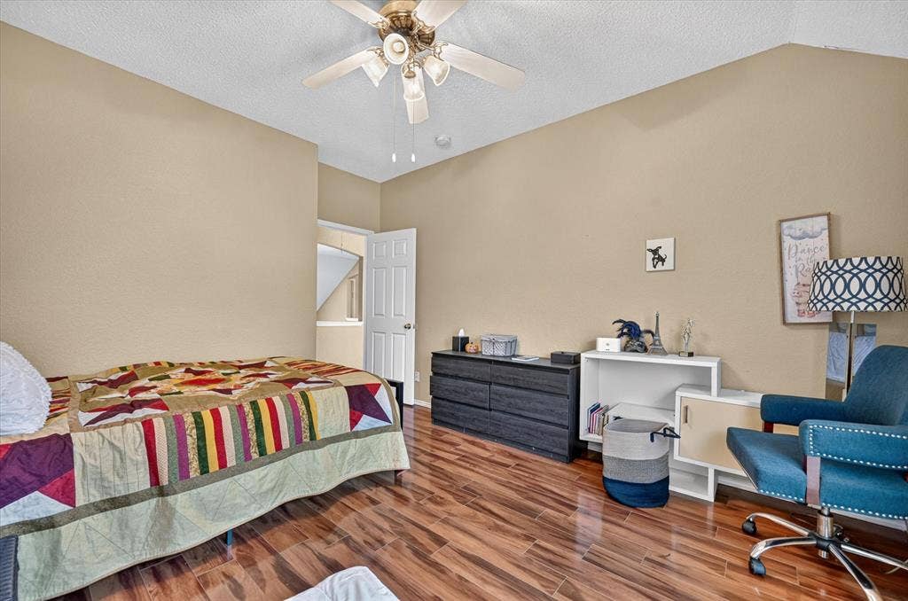 1625 Falmouth Drive, Plano, TX 75025 Spacious bedroom featuring wood-finish flooring, soft neutral wall tones, and abundant natural light from recessed ceiling fixtures