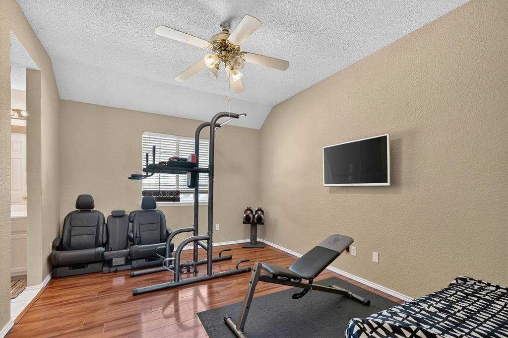 1625 Falmouth Drive, Plano, TX 75025 Room featuring wood-finish flooring, neutral wall paint, and a textured ceiling