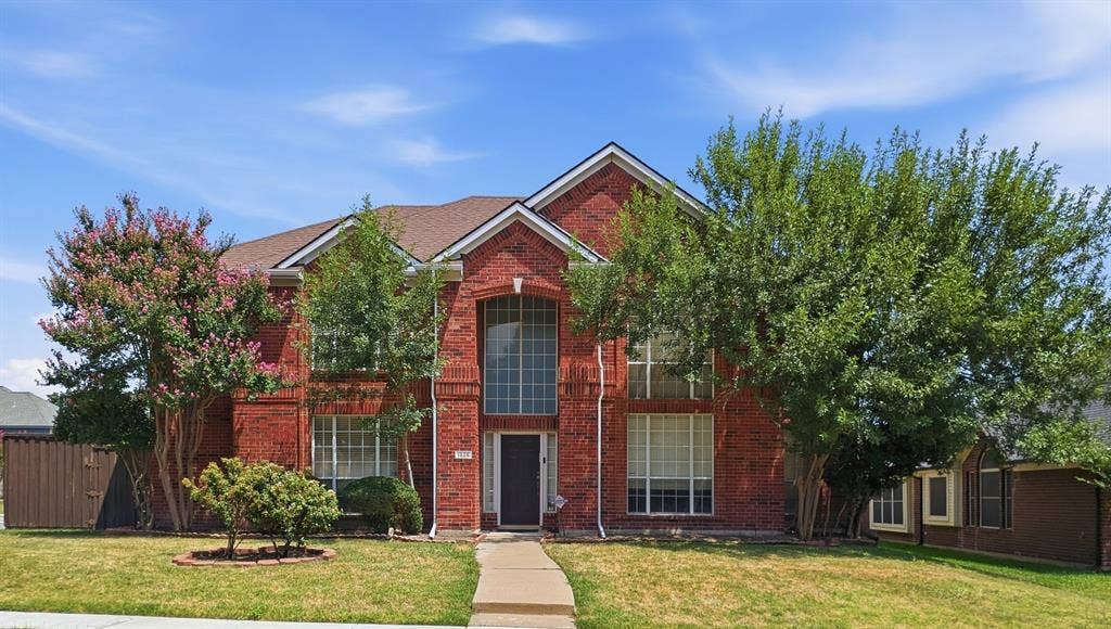 1625 Falmouth Drive, Plano, TX 75025 Red brick residence featuring a prominent arched window above the front entrance