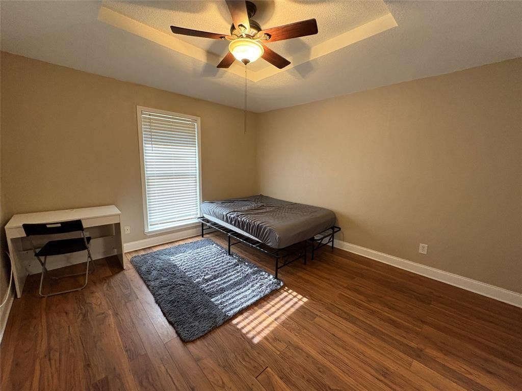 Primary bedroom with ceiling fan