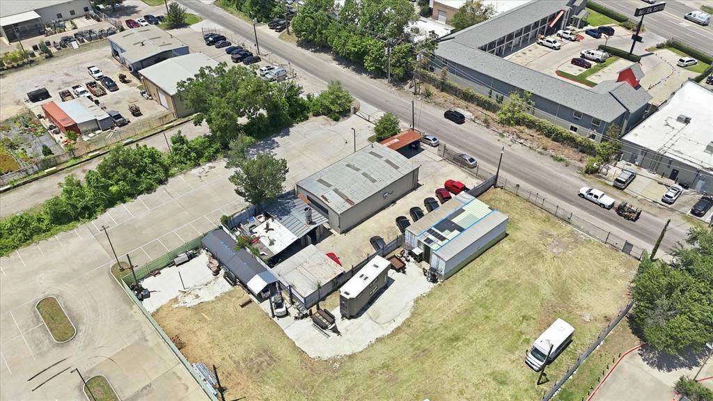 2136 California Crossing Road, Dallas, TX 75220 Commercial property featuring multiple structures, paved parking areas, and an expansive grass lot