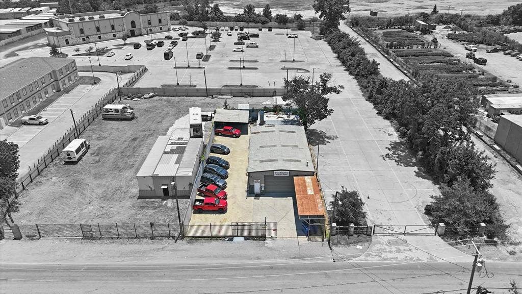 2136 California Crossing Road, Dallas, TX 75220 Commercial property featuring a primary building with an attached carport, an adjacent paved parking area, and two additional modular structures