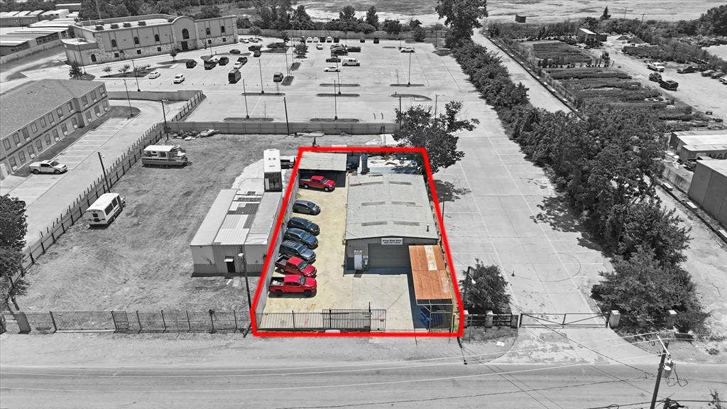 2136 California Crossing Road, Dallas, TX 75220 Commercial property featuring a primary building with a metal roof and an attached covered loading area