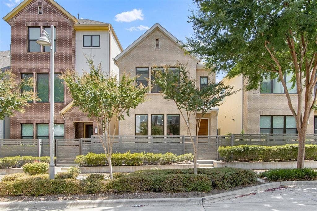 7867 Verona Place, Dallas, TX 75231 Contemporary townhome featuring a light brick facade and dark-framed windows