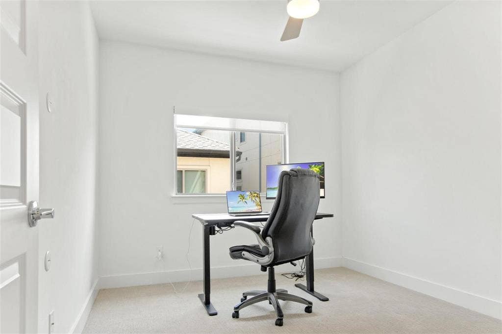 7867 Verona Place, Dallas, TX 75231 Bright room featuring a single window, a ceiling fan, and neutral carpeting
