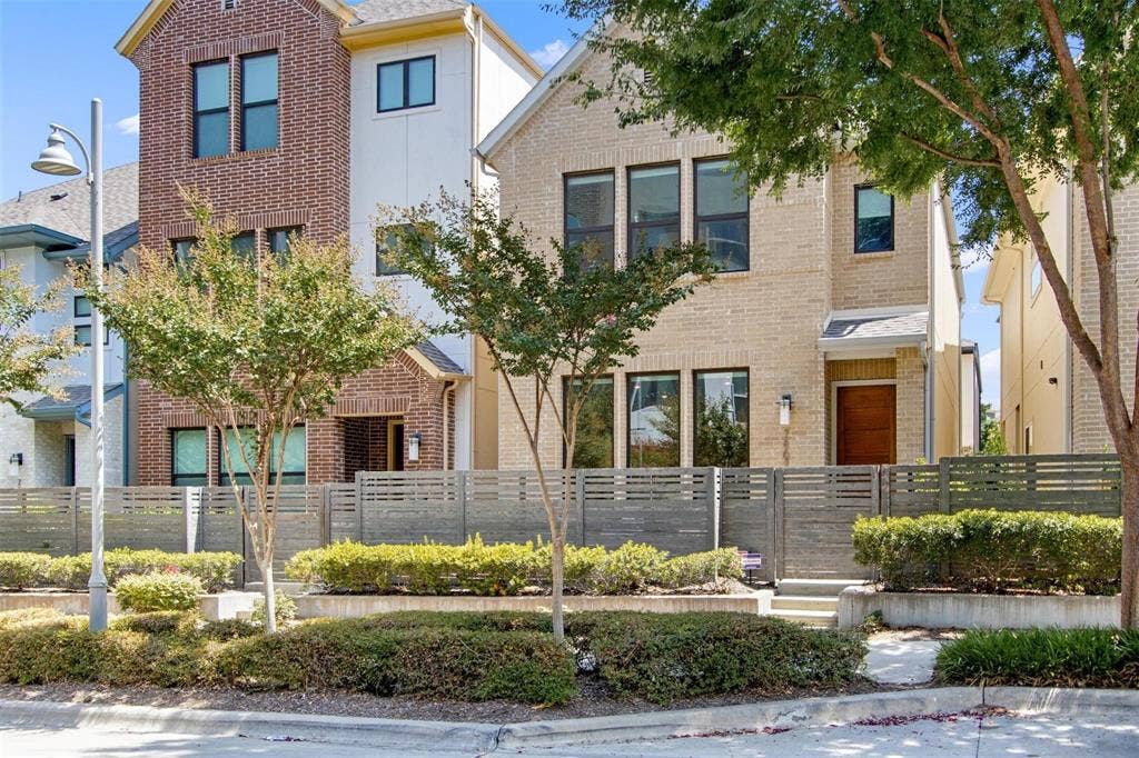 7867 Verona Place, Dallas, TX 75231 Contemporary two-story residence featuring a light brick facade and dark-framed windows