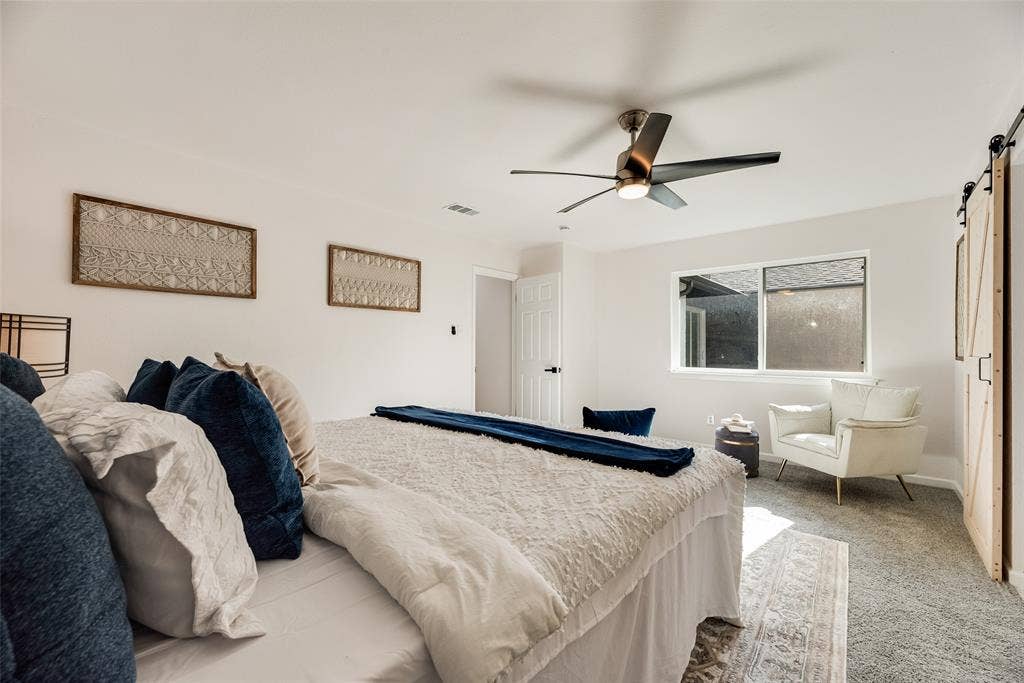 Spacious interior with neutral walls and light gray carpeting
