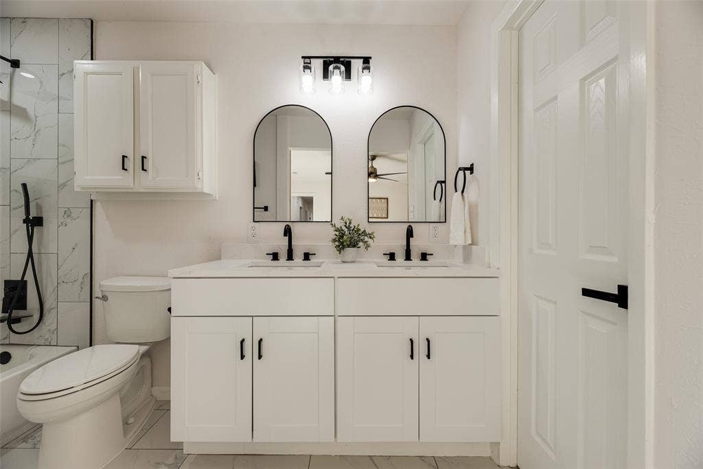 Dual vanity featuring undermount sinks, white countertops, and matte black fixtures