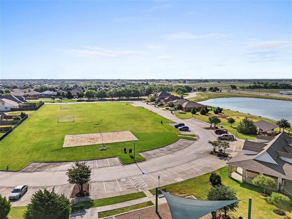 2920 Roper Street, Royse City, TX 75189 Expansive green space featuring a sand volleyball court, soccer goals, and a paved parking area