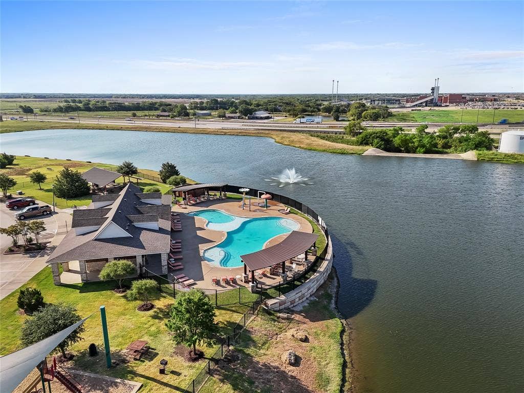 2920 Roper Street, Royse City, TX 75189 Community clubhouse featuring a freeform swimming pool with a covered lounge area
