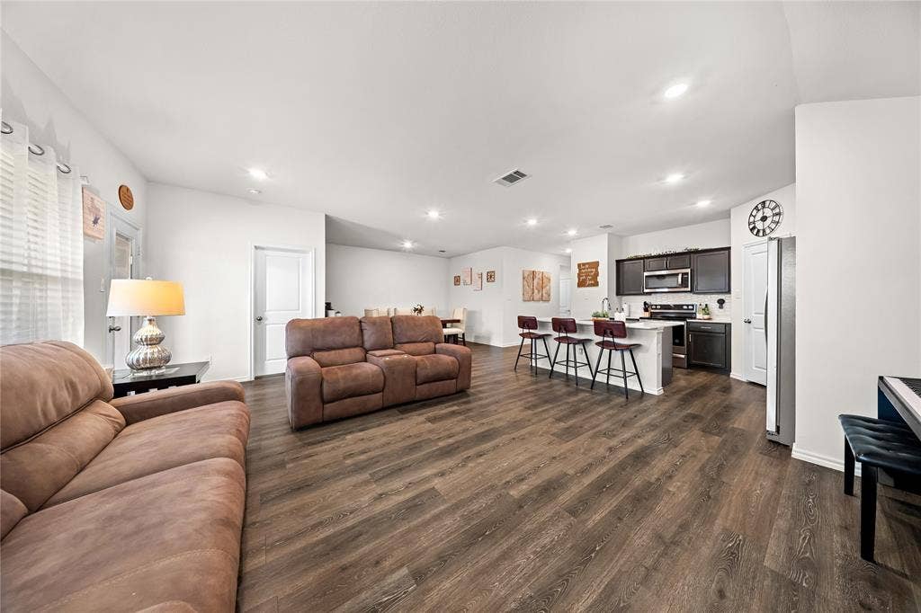 2920 Roper Street, Royse City, TX 75189 Open-concept living space featuring wood-finish flooring, recessed lighting, and white walls