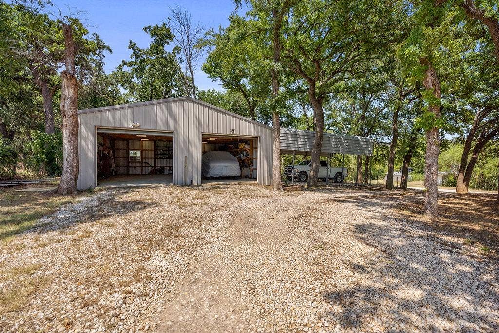 1510 Stanford Court, Denton, TX 76210 Oversized 2 car garage with view of RV carport