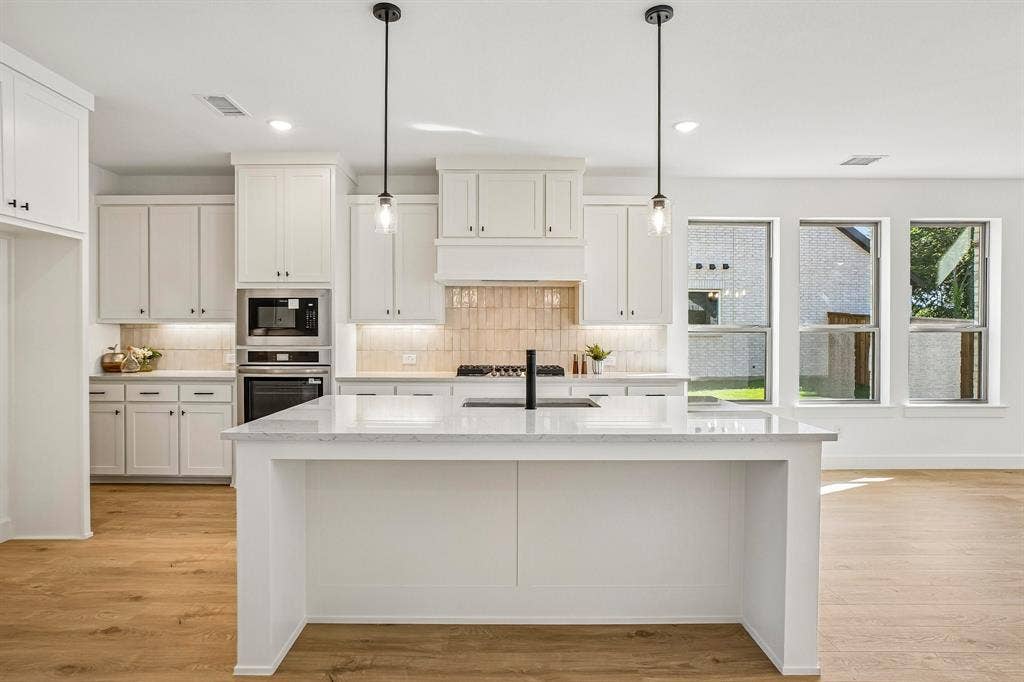 1516 Rose Mallow Road, Celina, TX 75009 The spacious kitchen island is the hub of your new chefs kitchen and the perfect place for friends and family to gather round!