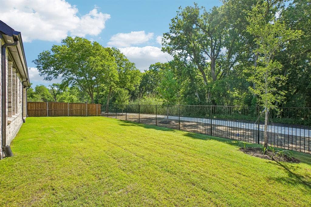 1516 Rose Mallow Road, Celina, TX 75009 Featuring a fenced yard backing to a lush greenbelt, you'll enjoy beautiful views from this dream home!