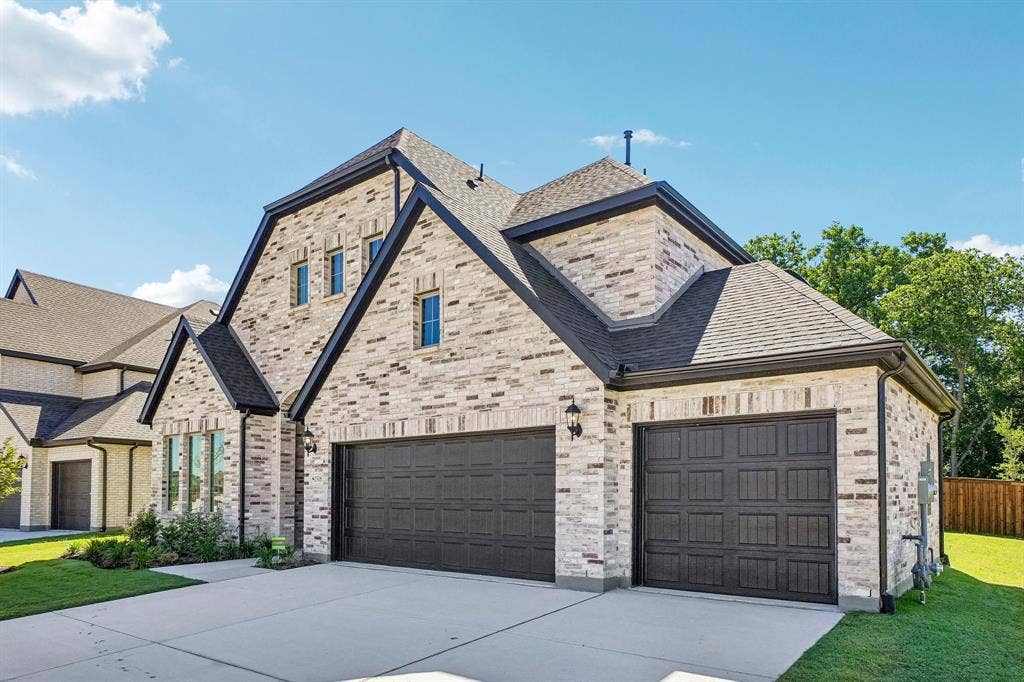 1516 Rose Mallow Road, Celina, TX 75009 With neutral brick and striking dark trim, this dream home offers a 3 car garage and tons of curb appeal!