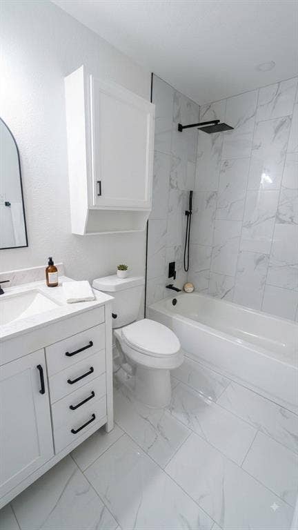White vanity with black hardware, integrated sink, and white countertop