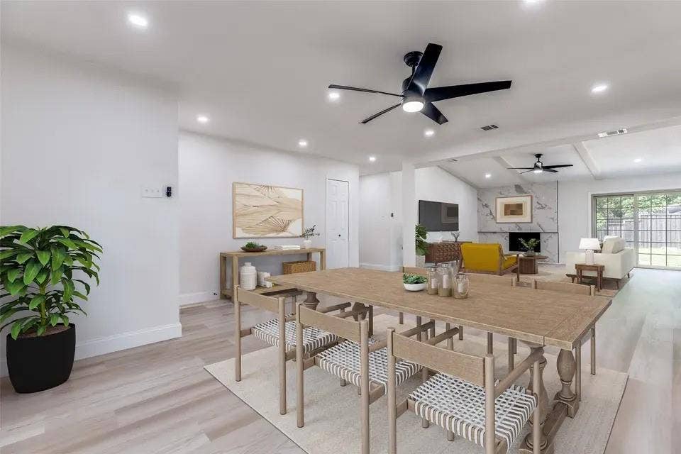 Open-concept interior featuring light wood-finish flooring, recessed lighting, and a modern ceiling fan