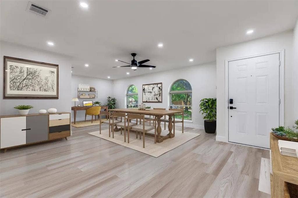 Open-concept living and dining area featuring wood-finish flooring throughout, recessed lighting, and a ceiling fan
