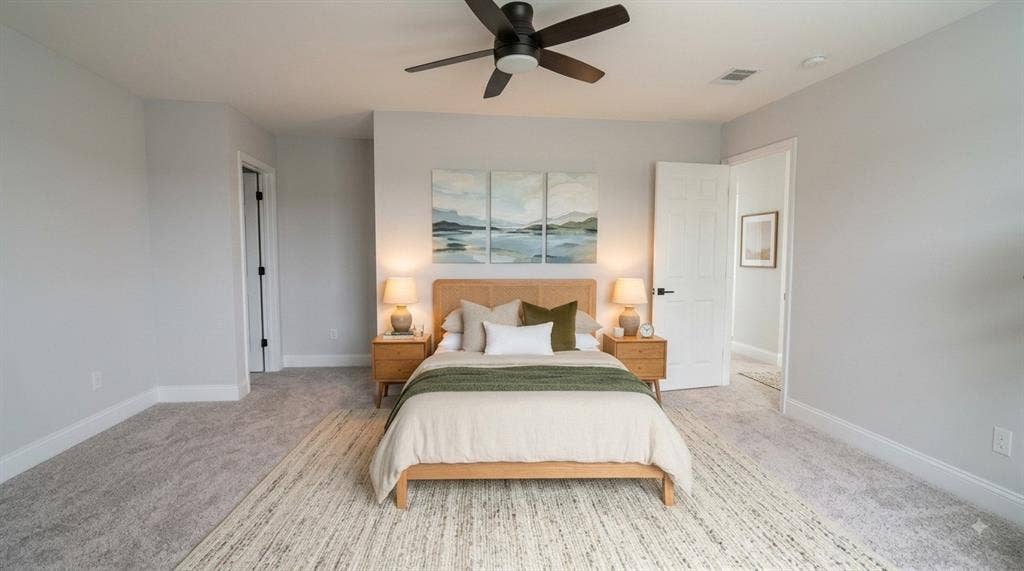 Ceiling fan, wall-to-wall carpeting, white interior doors, and neutral wall paint