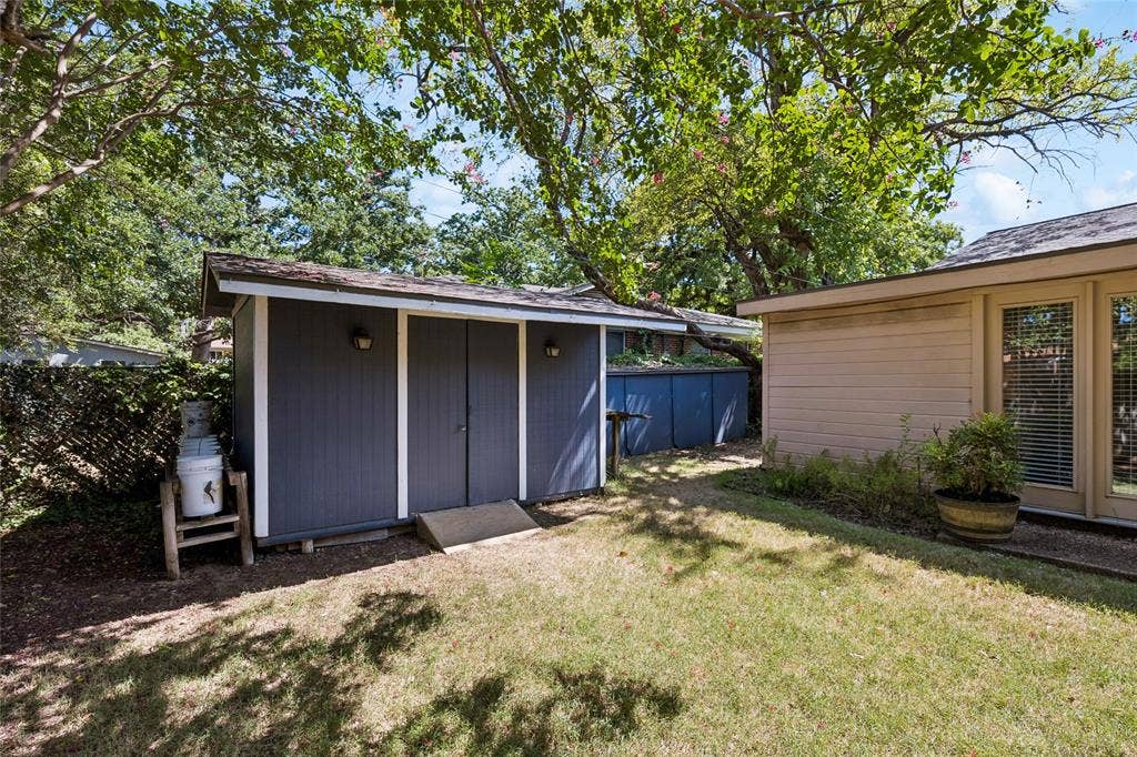 505 Caduceus Lane, Hurst, TX 76053 Storage barn has electricity and ample room for lawn equipment.