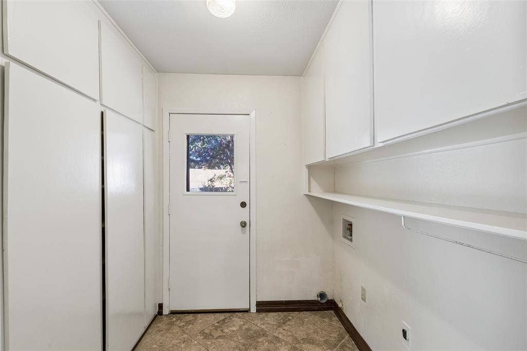 505 Caduceus Lane, Hurst, TX 76053 Built in cabinets in laundry. Door opens to back yard.