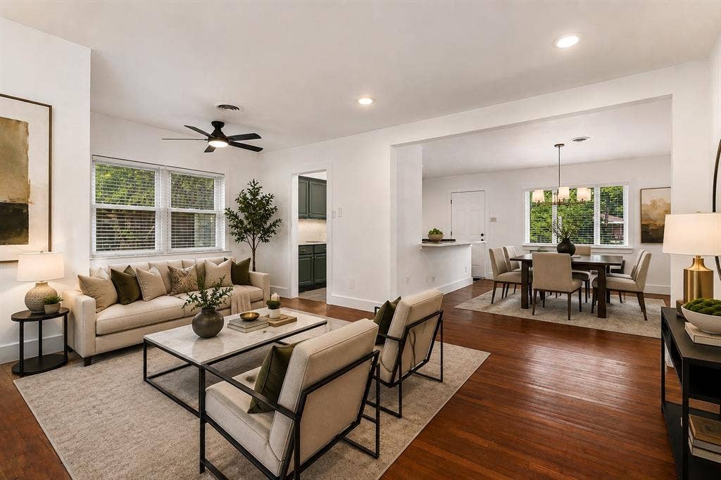 2251 Hartline Drive, Dallas, TX 75228 Designed for both comfort and effortless entertaining, this beautifully renovated living room welcomes you with an open-concept layout, rich hardwood flooring, and an abundance of natural light streaming through oversized windows. The spacious design creates an inviting atmosphere while seamlessly connecting the main living area and dining
