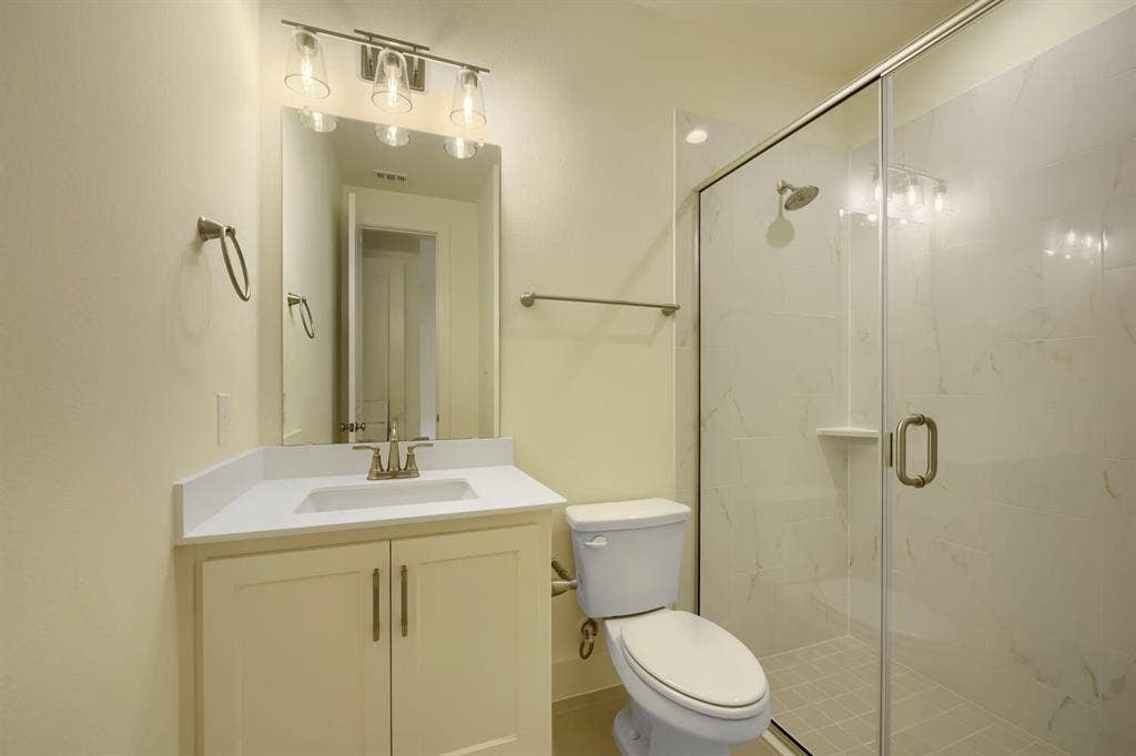 690 Red Cedar Road, Haslet, TX 76052 White vanity with a single basin, brushed nickel faucet, and integrated mirror
