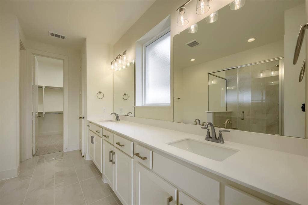 690 Red Cedar Road, Haslet, TX 76052 Dual sink vanity with white cabinetry, integrated sinks, and chrome fixtures
