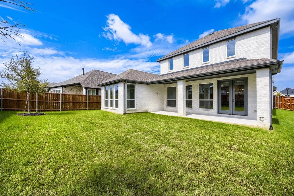 1281 White Pine Drive, Haslet, TX 76052 Expansive lawn featuring a newly planted tree, a covered patio, and a privacy fence