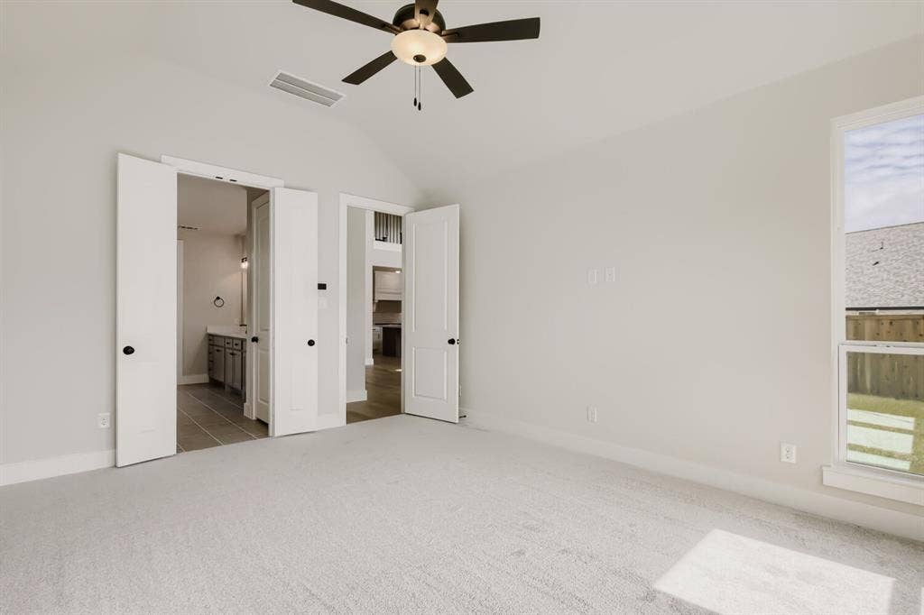 1281 White Pine Drive, Haslet, TX 76052 Carpeted room with vaulted ceiling and ceiling fan