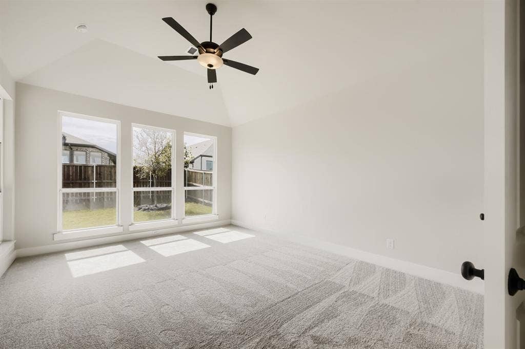 1281 White Pine Drive, Haslet, TX 76052 Vaulted ceiling with a contemporary ceiling fan, triple windows, and light-toned patterned carpeting