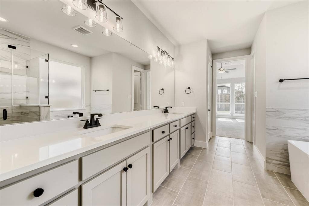 1281 White Pine Drive, Haslet, TX 76052 Dual vanity with quartz countertops, undermount sinks, and matte black fixtures