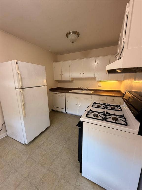 5106 Reiger Avenue, Dallas, TX 75214 Kitchen featuring white cabinetry, a gas range, a double-basin sink, and vinyl tile flooring