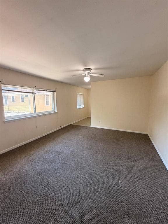 5106 Reiger Avenue, Dallas, TX 75214 Interior space featuring neutral wall tones, wall-to-wall carpeting, multiple windows with horizontal blinds, and a central ceiling fan with an integrated light fixture