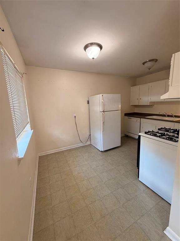 5106 Reiger Avenue, Dallas, TX 75214 Kitchen featuring white cabinetry, a built-in gas range, a dishwasher, and tile flooring