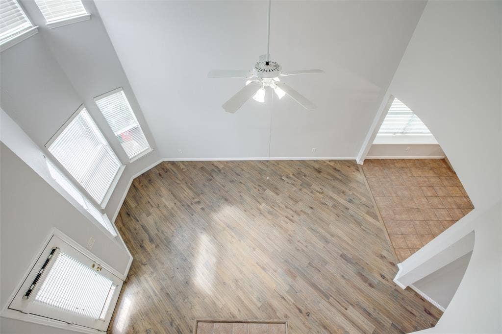 3401 Maddock Drive, McKinney, TX 75070 Soaring ceilings with a white ceiling fan and multiple windows for abundant illumination