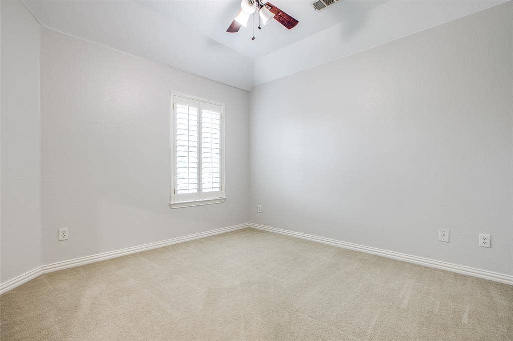 3401 Maddock Drive, McKinney, TX 75070 Spacious bedroom featuring neutral wall finishes, neutral carpet flooring, and abundant natural light from a shuttered window