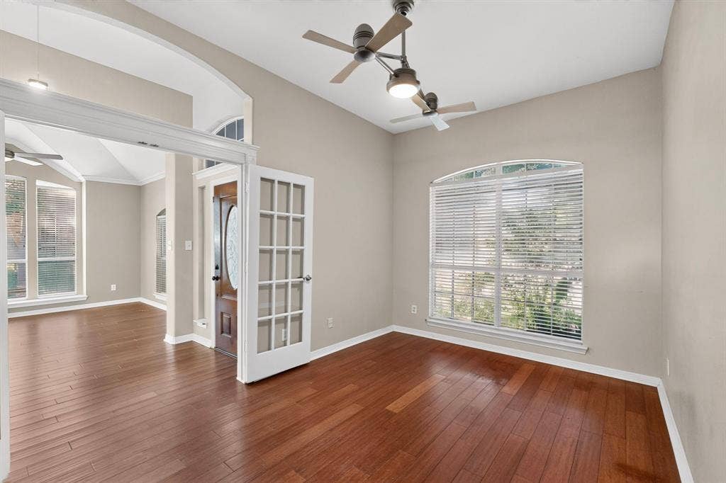 713 Mockingbird Court, Crowley, TX 76036 Wood-finish flooring, vaulted ceiling, arched doorways, French doors, and an arched window