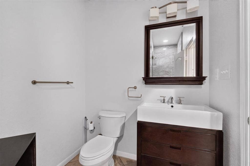 713 Mockingbird Court, Crowley, TX 76036 White porcelain toilet