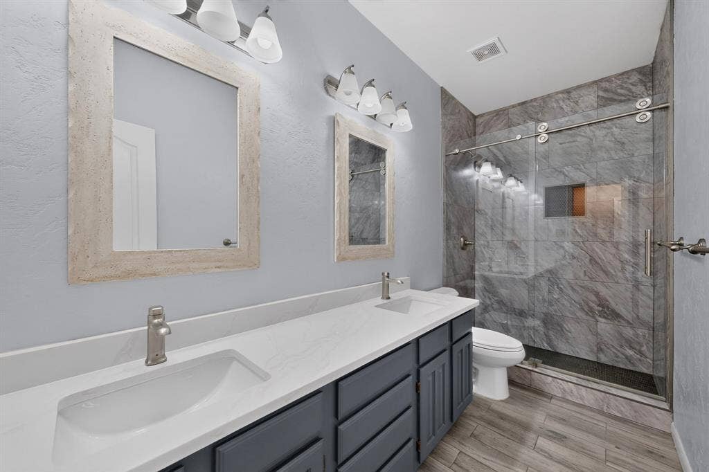 713 Mockingbird Court, Crowley, TX 76036 Dual vanity with integrated sinks, brushed nickel faucets, and framed mirrors