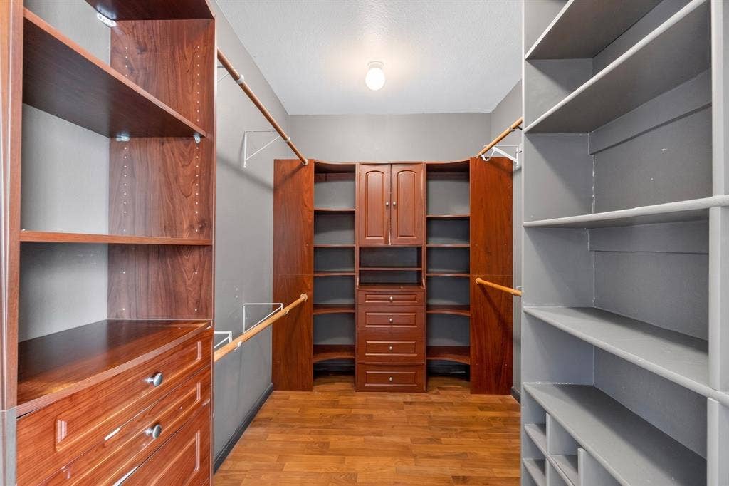 713 Mockingbird Court, Crowley, TX 76036 Walk-in closet featuring wood-finish flooring, built-in shelving, integrated drawers, and hanging rods