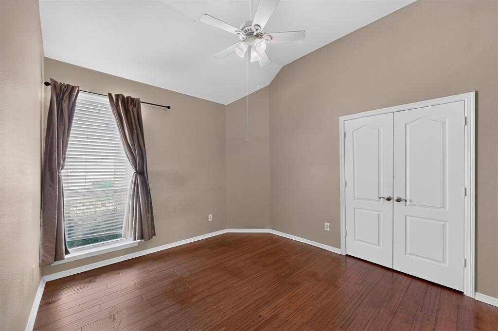 713 Mockingbird Court, Crowley, TX 76036 Vaulted ceiling, wood-finish flooring, ceiling fan, double doors, and window with blinds