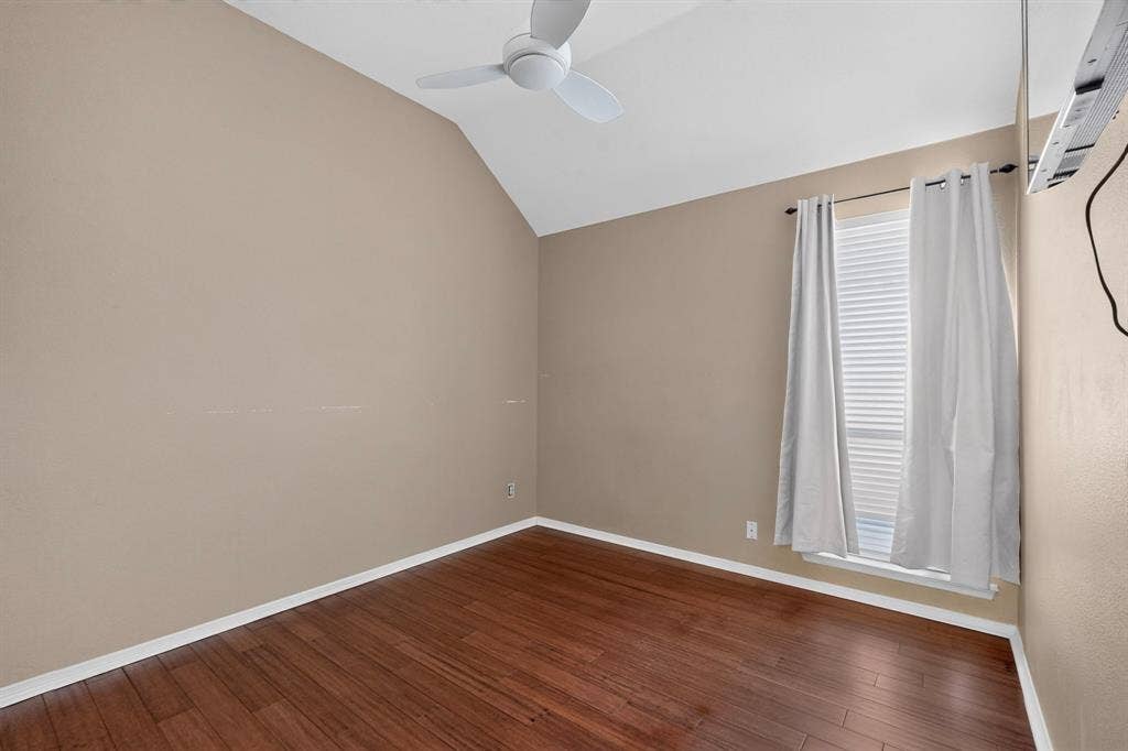 713 Mockingbird Court, Crowley, TX 76036 Vaulted ceiling with a ceiling fan, window with blinds, and wood-finish flooring